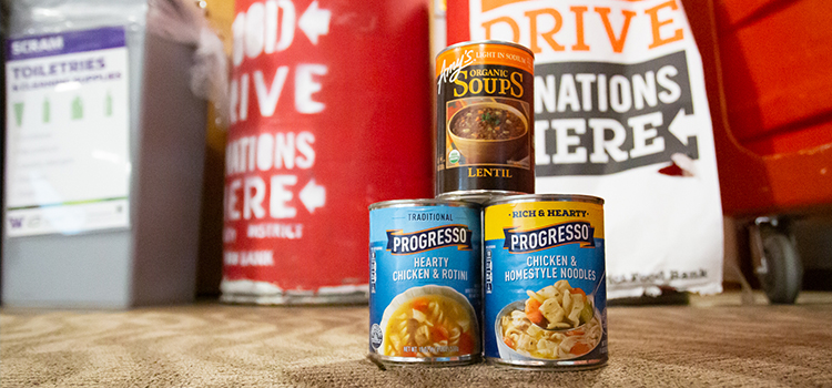 canned goods on the floor in front of donation bins