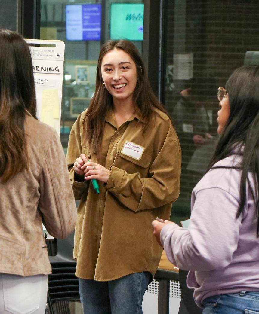 Elena Hamblin talking with students at an event