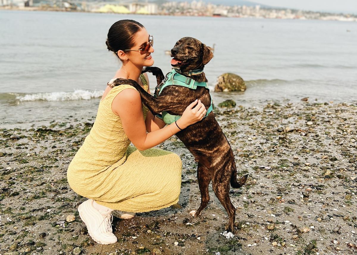 Emily Adams on a beach with her dog