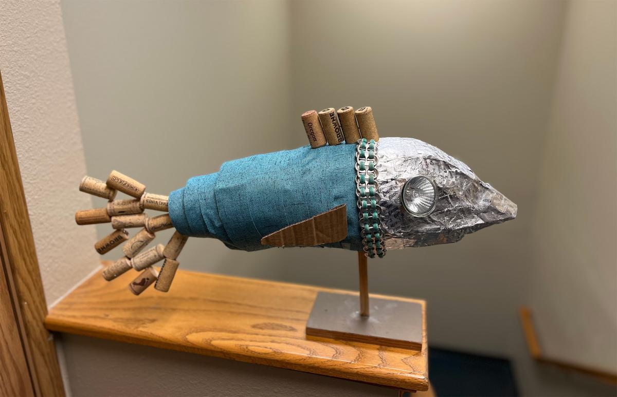 fish sculpture made from trash items