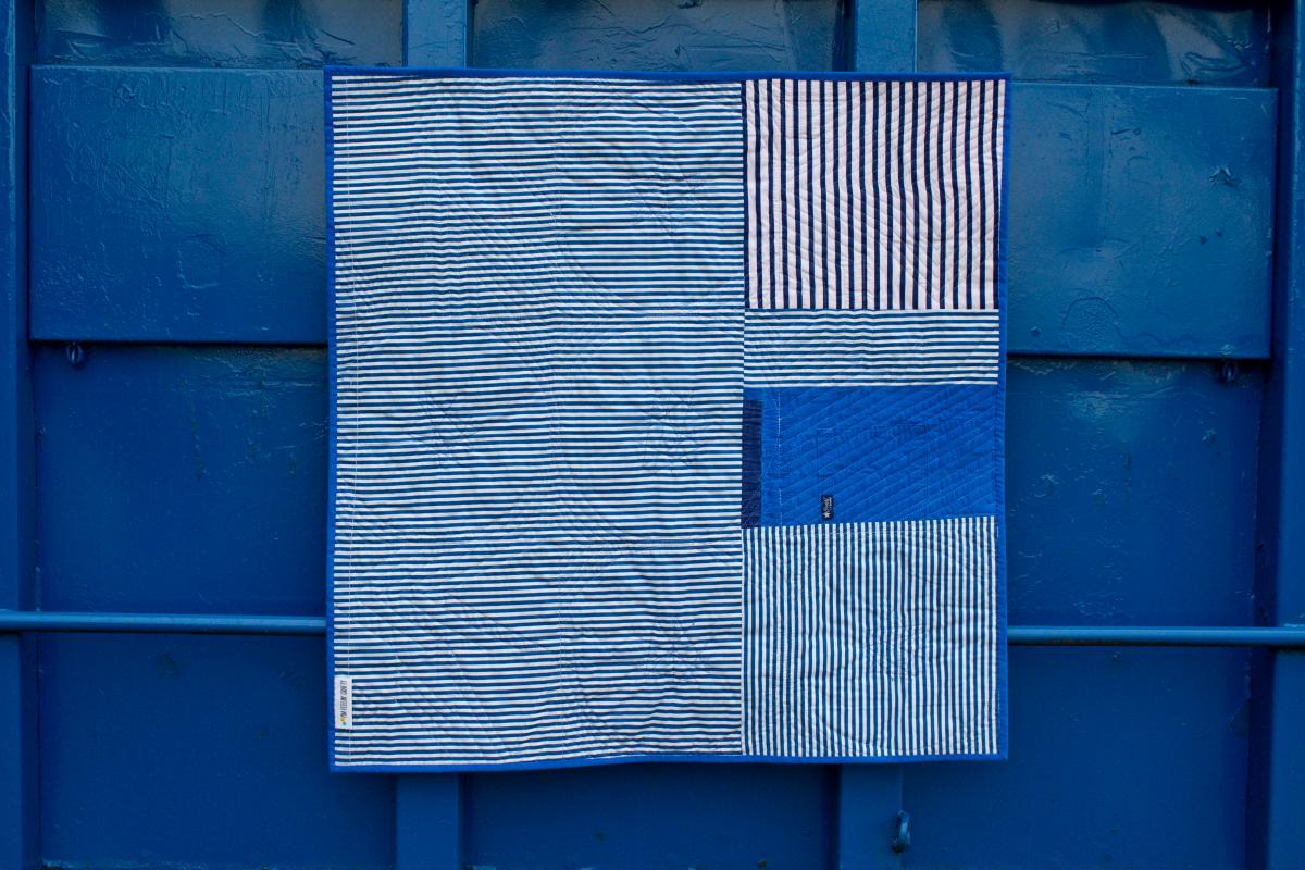 quilt created from disposable masks, disposable gloves and used scrubs