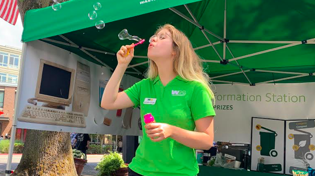 Gabrielle Coeuille blowing bubbles at WM outreach event