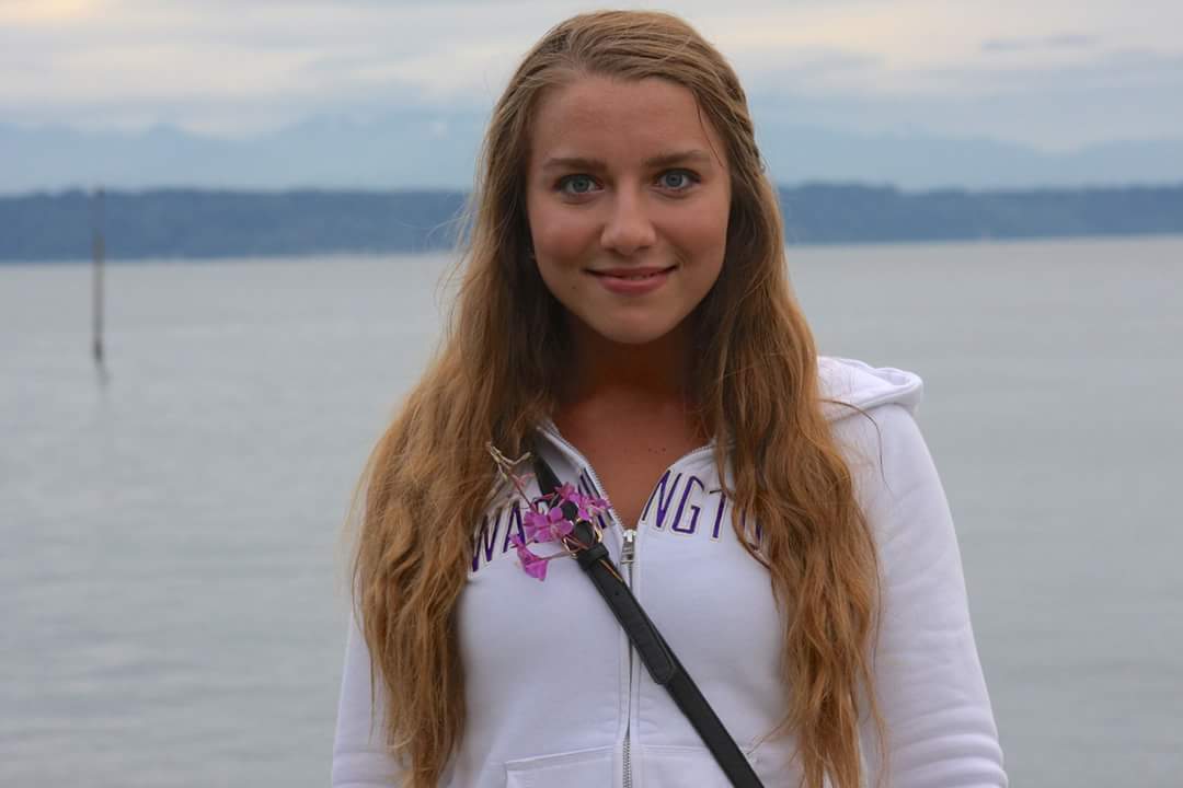 Karina Mazhukhina in front of a body of water.