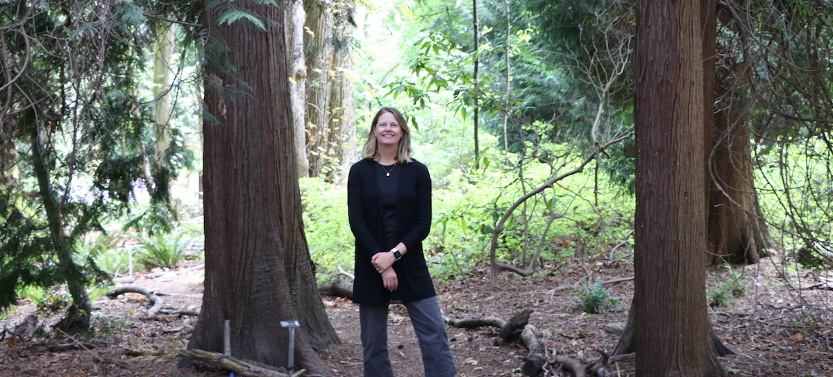 Lisa Dulude in wooded area on campus