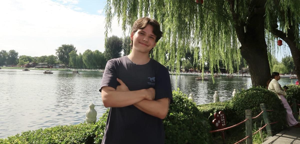 Noah Babai posing in front of a lake