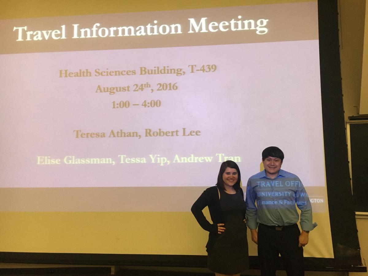 Presenters from UW Travel in front of their projected presentation.