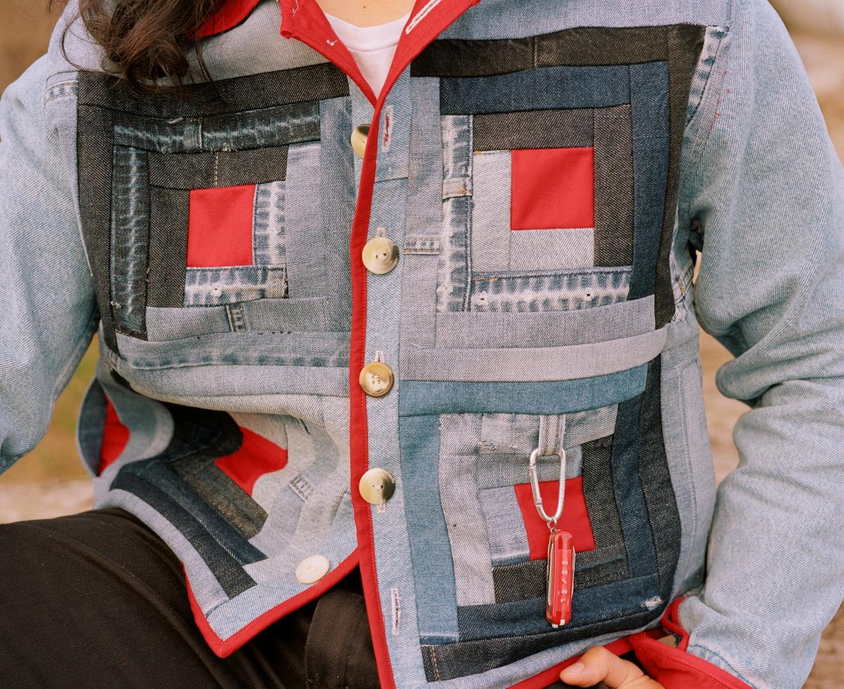 jacket made with a quilting pattern with multiple pieces of denim and buttons