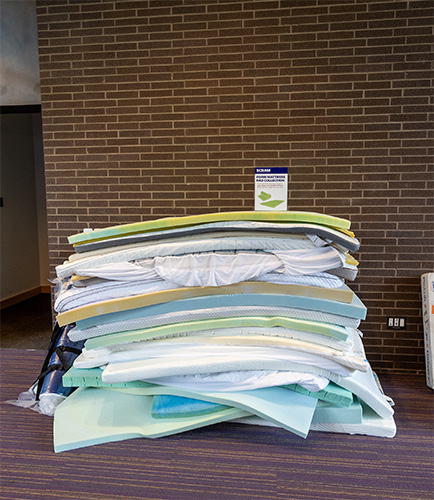 stack of more than 25 foam mattress pads