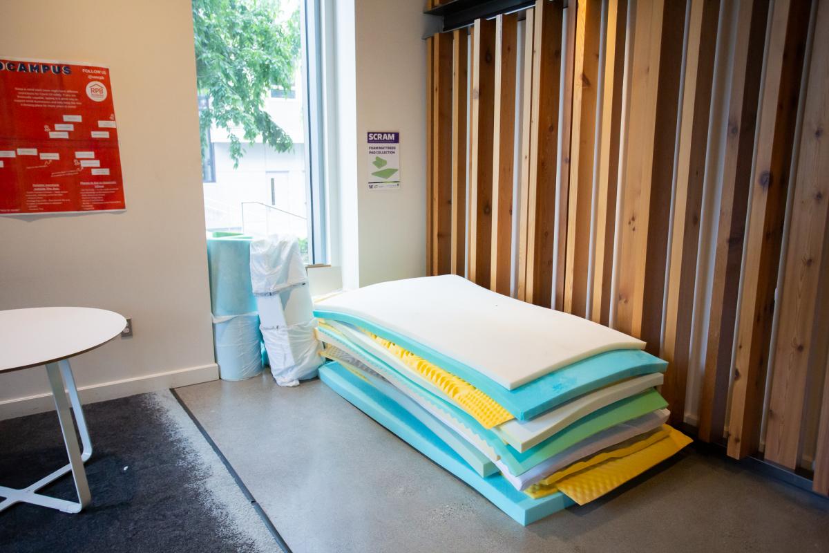 multiple foam mattresses on ground in residence hall