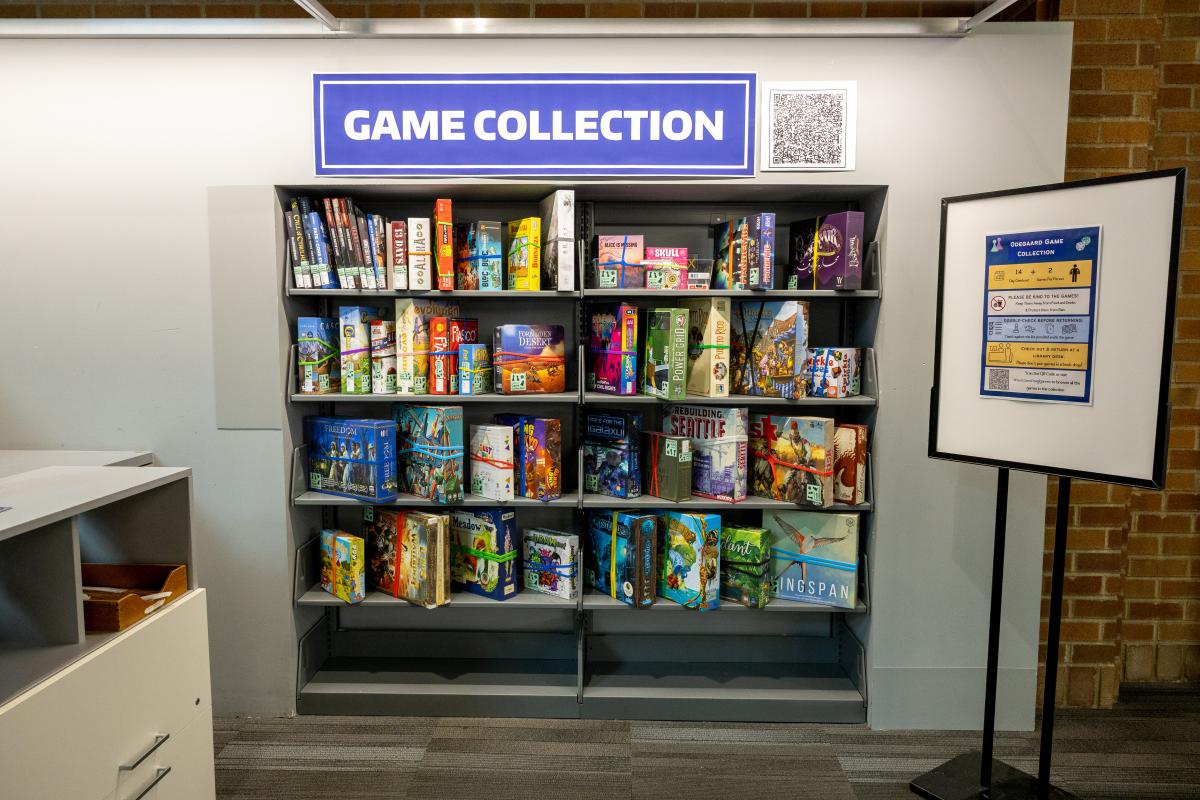 wall of board and card games with a poster that reads game collection