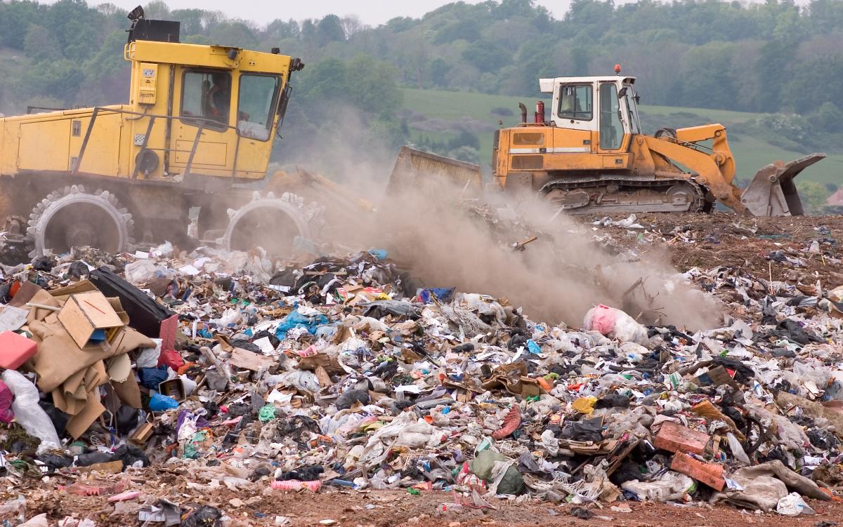 landfill with two bulldozers moving material