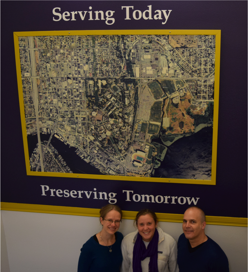 Members of the water irrigation team posed in front of a map of campus.