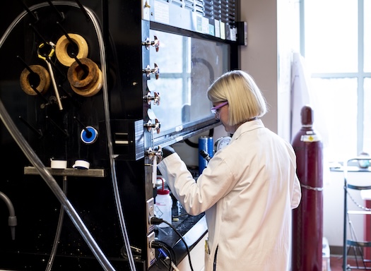 UW scientist working in fume hood