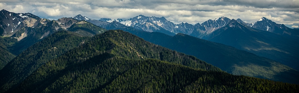 view of mountains on the Olympic Peninsula with clouds above