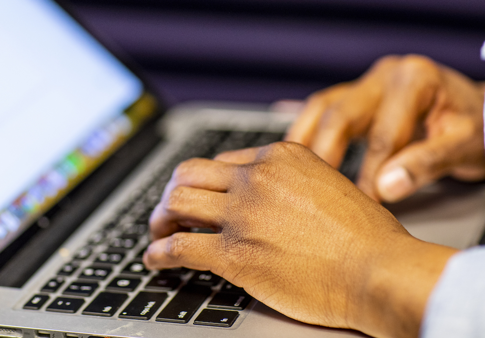 hands on a laptop keyboard