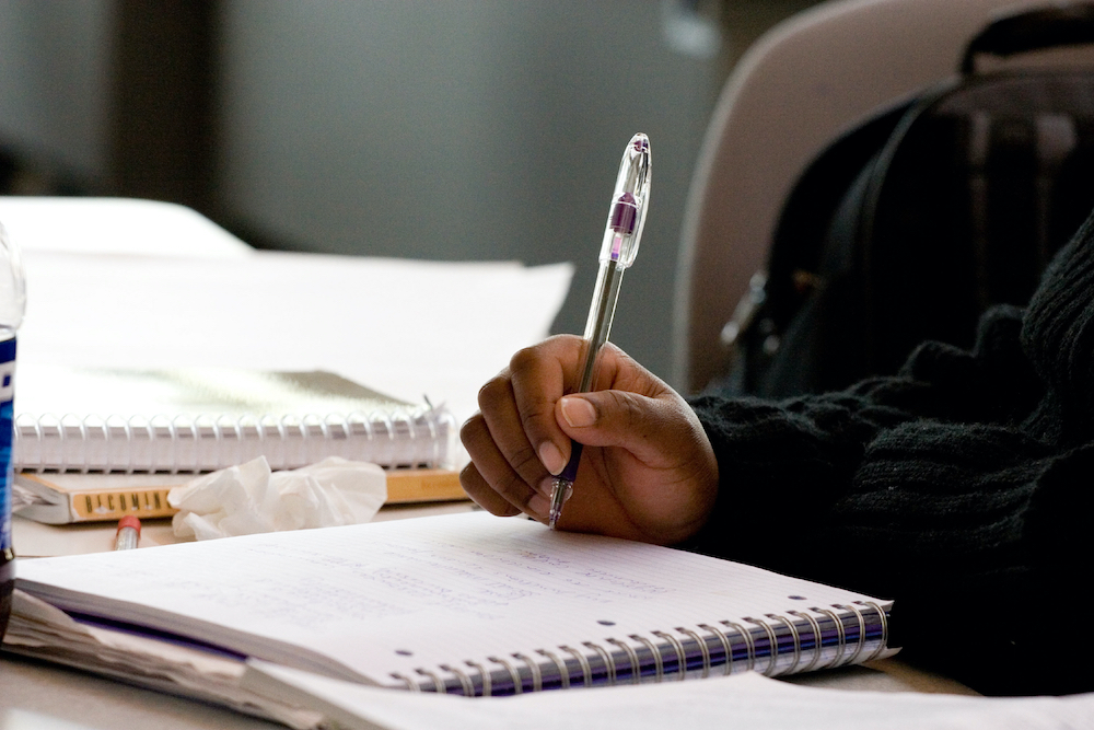 close-up of the hand of student taking notes