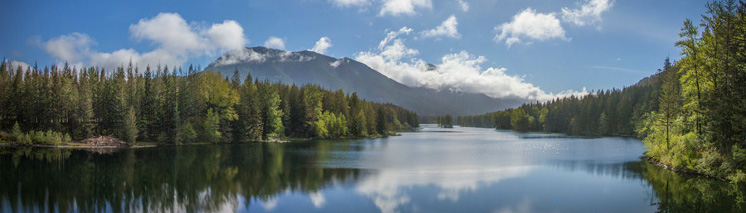 picture of a lake with mountains in the background