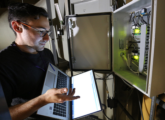 UW staffer using a laptop to connect to energy meter data